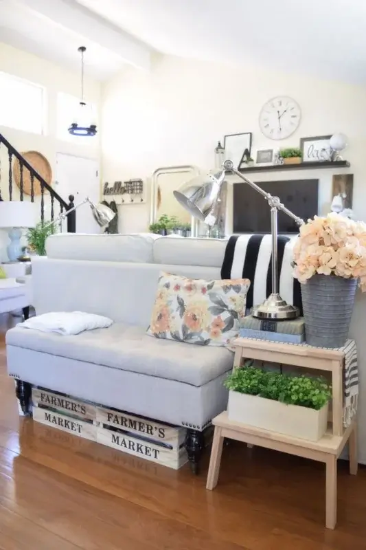Small console decor behind sofa using stacked crates, table lamps, plants, and farmhouse accents for budget friendly sofa table ideas