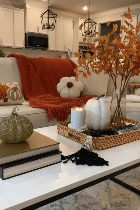 Decorative bowl filled with pinecones, acorns, and autumn leaves for simple natural fall living room decor