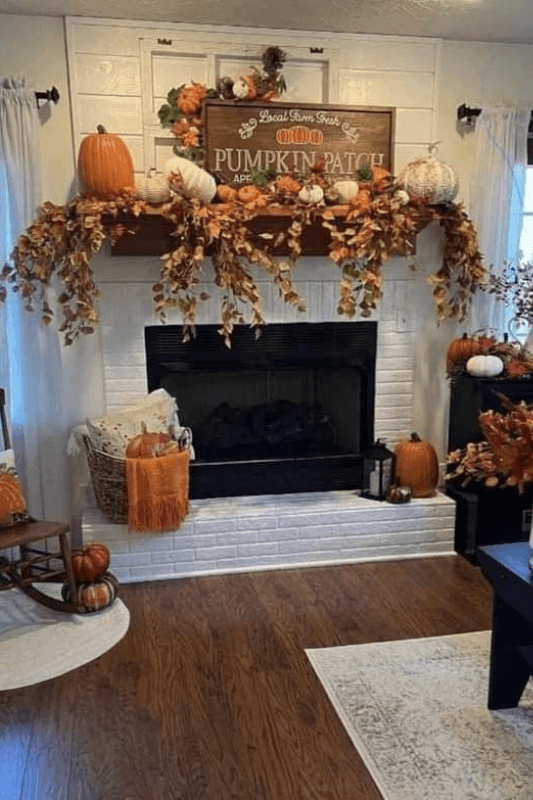 Fall fireplace mantel decor with pumpkins, autumn garland, seasonal sign, baskets, and warm farmhouse accents