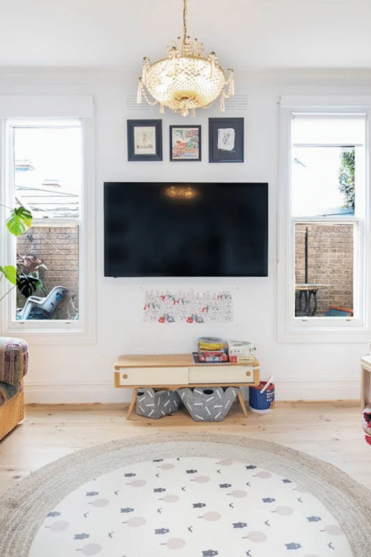 minimalist tv wall with wooden bench and framed art