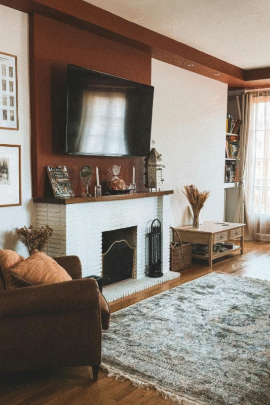 terracotta tv wall design with white brick fireplace