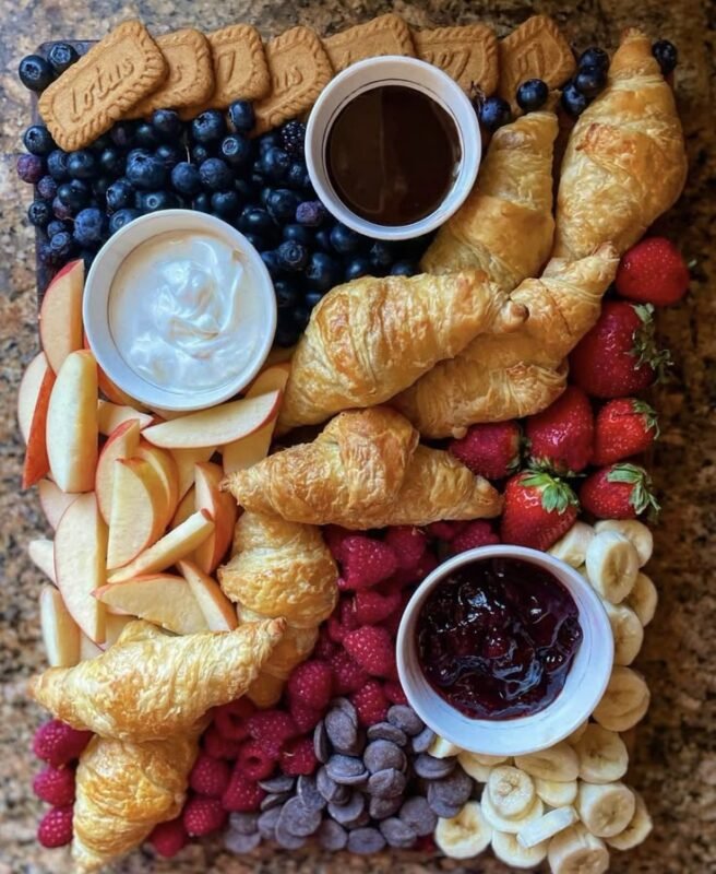 sweet and savory dessert charcuterie board with brie honey grapes and chocolate pieces