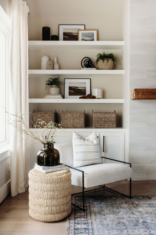 Symmetrical built-in shelves with balanced decor including oversized vases, greenery, books, and textured baskets.