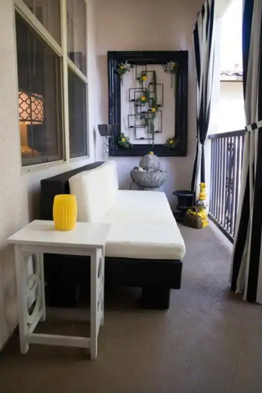 Cozy balcony with rattan chair, floor cushions, plants, and layered textures for a relaxed luxury vibe