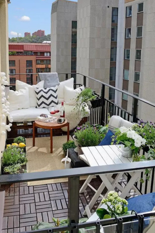 Small balcony dining area with foldable wooden furniture and flower boxes for functional elegance