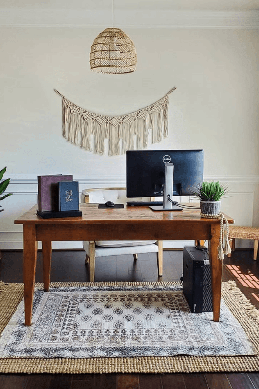 Home office with a vintage-style area rug layered over a large natural jute rug beneath the desk