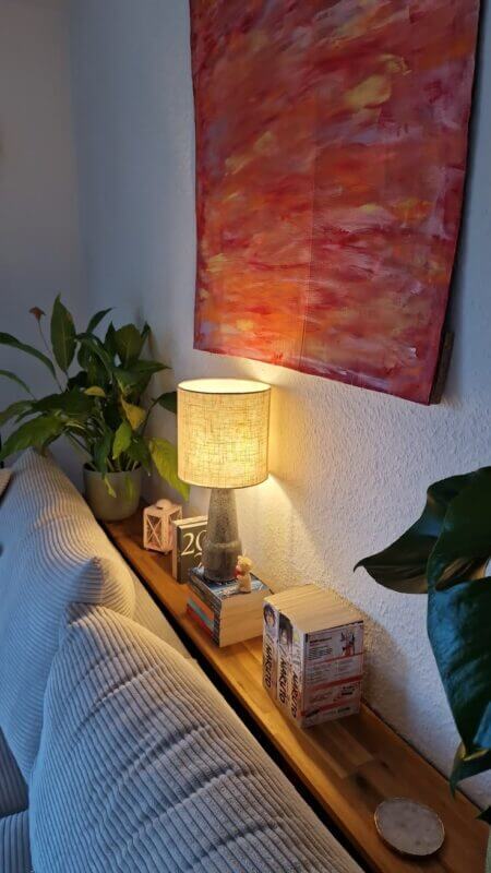 Table lamp on a narrow console behind the sofa adding soft ambient light